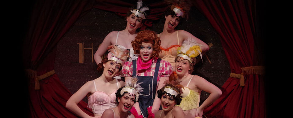 Group of female theatre students performing in a musical.