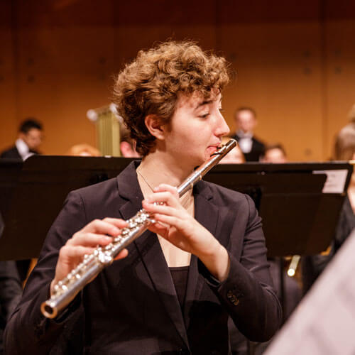 Flutist plays in the wind symphony ensemble.