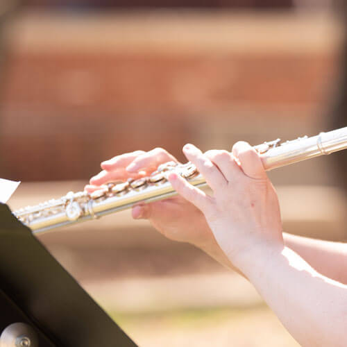 Student plays her flute.