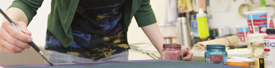 A student works on a painting.