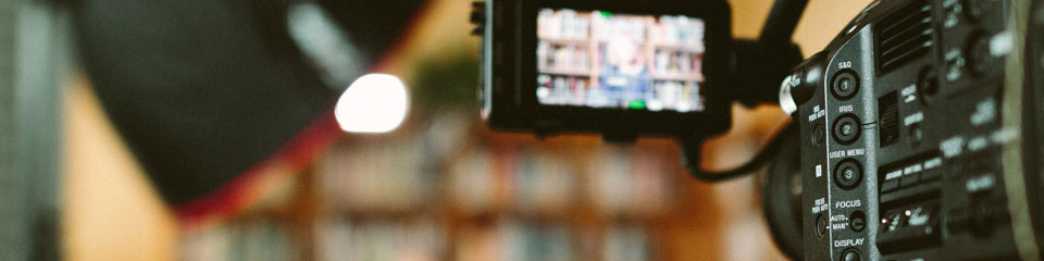 A close-up shot of a video camera while recording an interview.