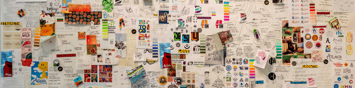 Samples of designs posted to a wall.