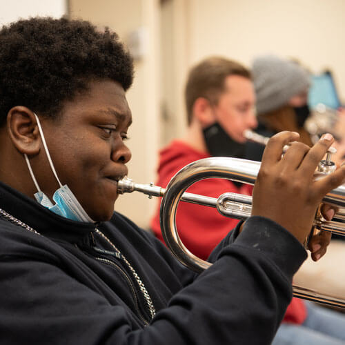 Student plays his trumpet in a jazz ensemble.