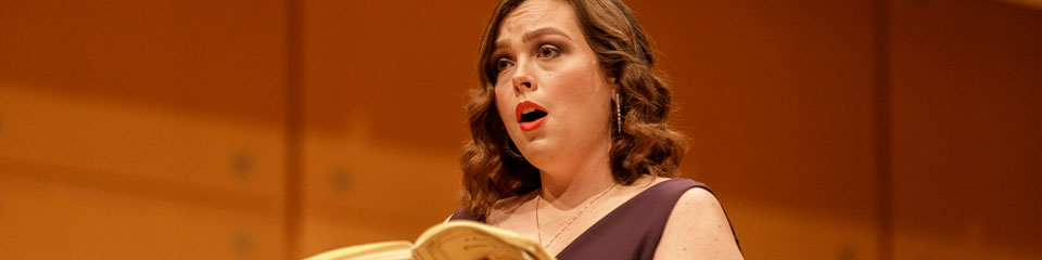 Student sings a solo at a choir concert.