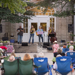 A band plays on the front steps of Cook Hall