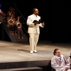 A student performs his work onstage.