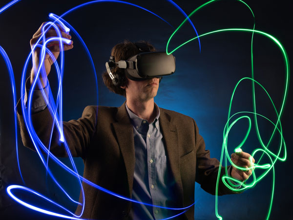 Professor Magnuson conducts while wearing a VR headset.