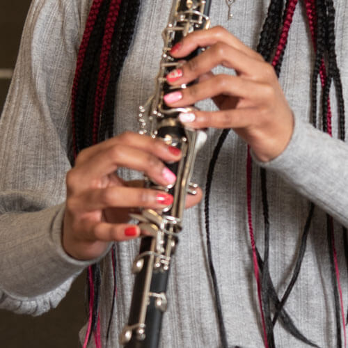 A student plays her clarinet.