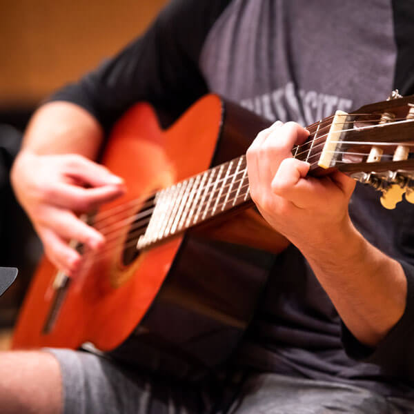 A student practices the guitar.