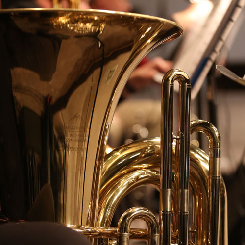 A euphonium player rests his instrument during a performance.