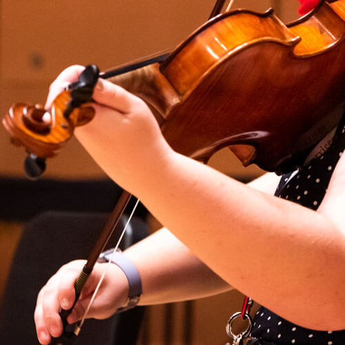 Student plays her viola in an ensemble.