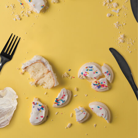 broken cake pieces with plastic silverware